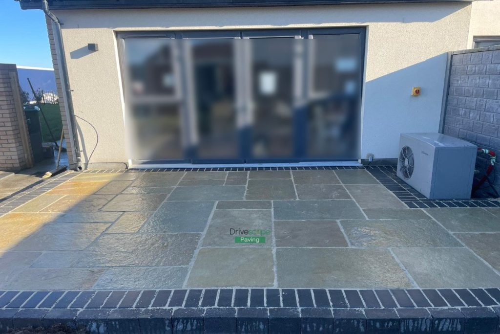 Patio with Tumbled Limestone Slabs and Brick Border in Dunshaughlin, Co. Meath